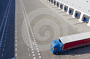 Aerial Shot of Industrial Warehouse Loading Dock, Truck with Semi Trailers Load Merchandise