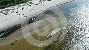 Aerial shot of kiteboarders and kitesurfers of the Baltic Sea Latvia aerial drone top view 4k.