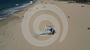 Aerial shot of lifeguard towers and beachgoers at Santa Monica State Beach in California