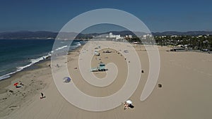 Aerial shot of lifeguard towers and beachgoers at Santa Monica State Beach in California