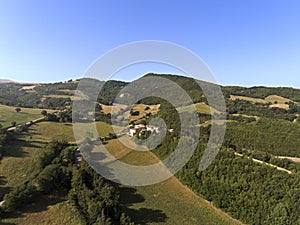 Aerial shot of a little village surrounded by nature of Monti Sibillini National Park , Collevecchio, Macerata, Italy