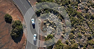 Aerial shot. Looking down. Car go new ideally flat asphalt road. Fresh white road markings. Against the background of