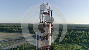 Aerial shot Maintenance personnel on cellular antenna at telecommunication tower