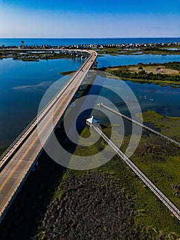 Aerial shot of a massive bridge on a river on a sunny day in Surf City, NC