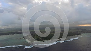 Aerial shot of Mauritius with low clouds and blue lagoons
