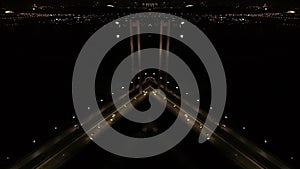 Aerial shot and mirror effect on a shot of a night city and huge bridge