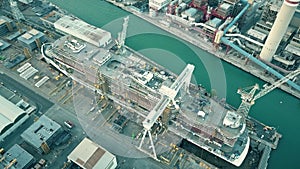 Aerial shot of modern hi-tech cruise ship under construction at the shipyard