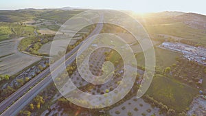 Aerial shot of modern interstate highway. Top view of fantastic green landscape