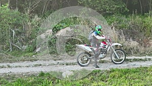 aerial shot of a motocross rider on a journey on a dirt and dusty country road driving fast and exploring beautiful