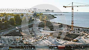 Aerial Shot of a New Construction Development Site with High Tower Cranes Building Real Estate. He