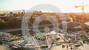 Aerial Shot of a New Construction Development Site with High Tower Cranes Building Real Estate. He