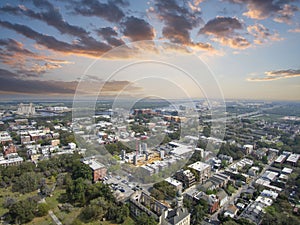 Aerial shot of the office buildings, apartments and shops in the city skyline along the Savannah River with with lush green trees