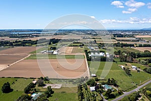 Aerial shot of Ohau village in the Horowhenua region of New Zealand with flat fertile farmland