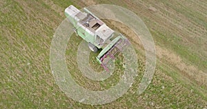 Aerial shot: An old chap combine harvester collecting ripe wheat