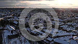 Aerial shot of Old City Lviv cowered by snow with churches and cathedrals.