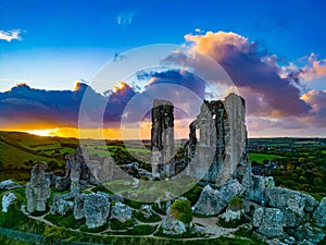 Aerial shot of an old ruins of Corfe Castle, Dorset during sunset