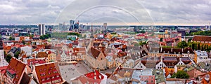 Aerial shot of the old town of Tallinn with orange roofs, churches' spires and narrow streets