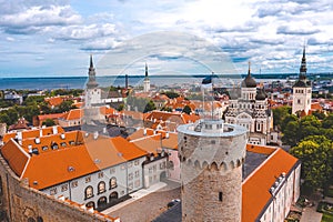 Aerial shot of the old town of Tallinn with orange roofs, churches' spires and the Toompea castle