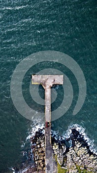 Aerial shot of the old wooden Portencross Pier in North Ayrshire, Scotland.