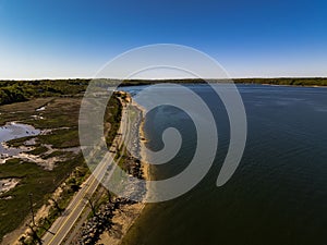 Aerial shot over West Neck Beach on Long Island in the suburb of Lloyd Harbor New York on sunny day