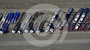 Aerial shot of parked car transporter trucks and trailers, top view. 4K video