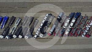 Aerial shot of parked car transporter trucks and trailers, top view