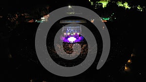 Aerial shot of people watching a concert at an open-air theater