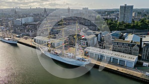 Aerial shot on port and sailing ships docked in city