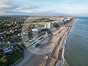 Aerial shot of a pristine beach, with several houses dotting the shoreline