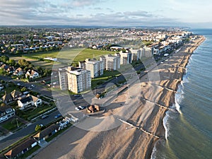 Aerial shot of a pristine beach, with several houses dotting the shoreline