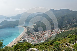 Aerial shot of pure water and green-covered hills of the Blue Lagoon in Oludeniz, Turkey