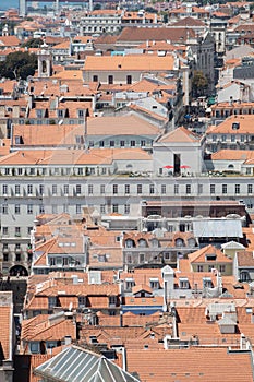 Aerial shot of red-roofed white buildings in the historic Alfama district in Lisbon, Portugal