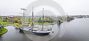 aerial shot of the residential area in Zaanse Schans, houses, windmills, a ship in the river