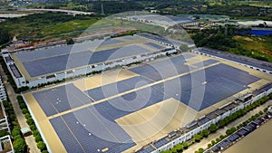 Aerial shot of roof of factory warehouse building in industrial area