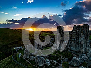 Aerial shot of the ruins of Corfe Castle, Dorset during sunset