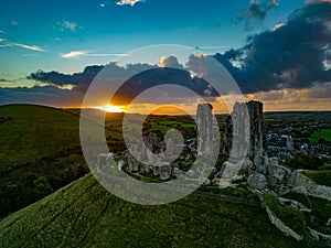 Aerial shot of the ruins of Corfe Castle, Dorset during sunset