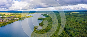 Aerial shot Rummu lake surrounded forest trees under a cloudy sky in Tallinn, Estonia