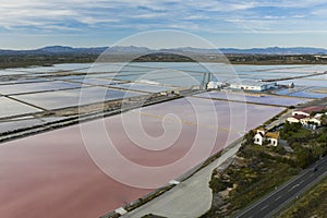 Aerial shot of salt factory in Santa Pola, Alicante, Costa Blanca, Spain. Salty pink red lakes on mediterranean sea coast