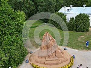 Aerial shot of a sand sculpture of a Ukrainian leader Zelenskyy symbolizing a statue of liberty