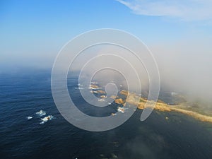 Aerial shot of a sea under a blue sky in caion. Galicia, Spain