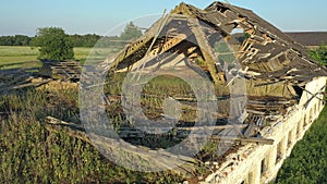 Aerial shot showing nature slowly taking over an old soviet cattle barn.