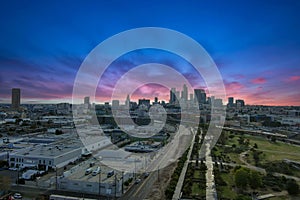 Aerial shot of the skyscrapers and office buildings in the city skyline over Los Angeles State Historic Park