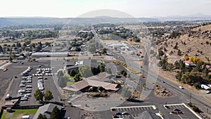 Aerial shot of the small town in Prineville Oregon with cars driving on the highway