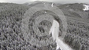 Aerial shot of snow-covered road in the countryside Carpathian Mountains