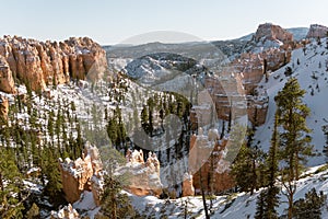 Aerial shot of snowy mountains and trees in Bryce Canyon National Park, Utah, United States