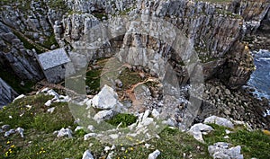 Aerial shot of st govan's chapel (tiny church) built on the cliff