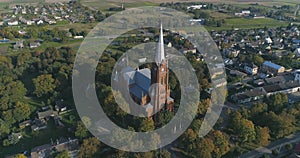 Aerial shot of St. John church of Ramygala in Lithuania. Panorama of city in early autumn.