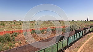 Aerial shot of stationary cargo train with empty wagons