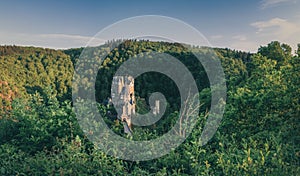 Aerial shot of the stunning Eltz castle in Germany, nestled among a vibrant green forest