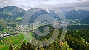 Aerial shot of successive forested hills, valleys and a small town, Bludenz, Vorarlberg, Austria